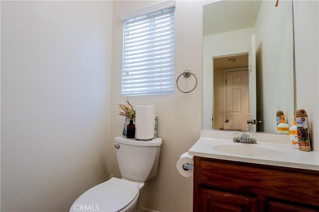 bathroom featuring toilet and vanity