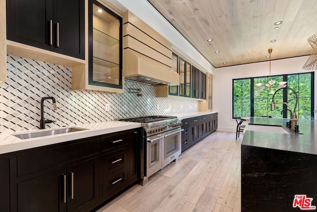 kitchen featuring decorative light fixtures, sink, light wood-type flooring, wood ceiling, and range with two ovens