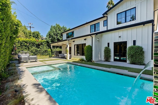 back of property with an outdoor hangout area and a patio