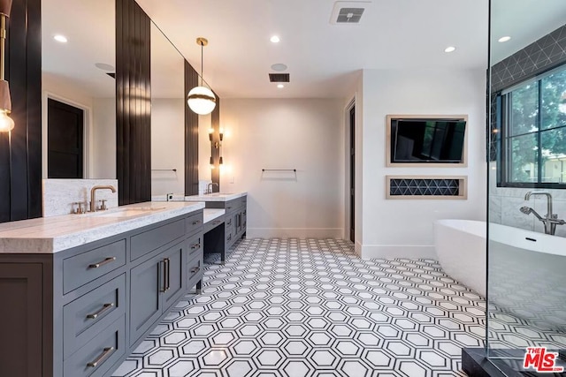 bathroom with vanity and a tub