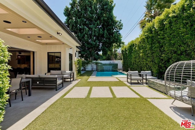 view of yard with a fenced in pool, outdoor lounge area, and a patio