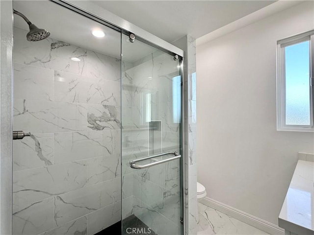 bathroom featuring toilet, an enclosed shower, and vanity