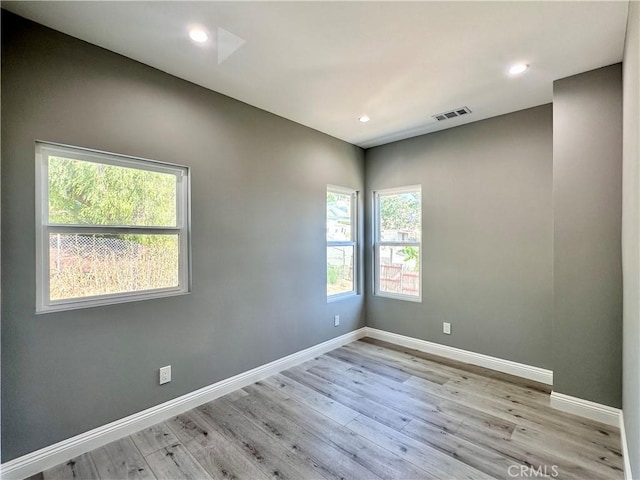 spare room with light hardwood / wood-style floors