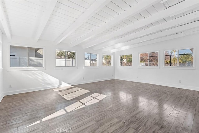 unfurnished sunroom with vaulted ceiling with beams