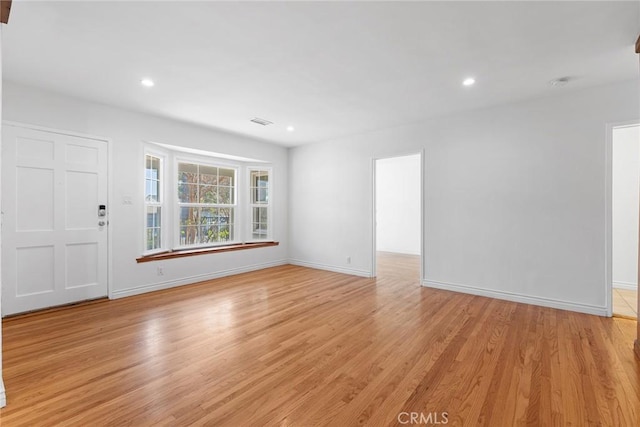 unfurnished living room featuring light wood-type flooring