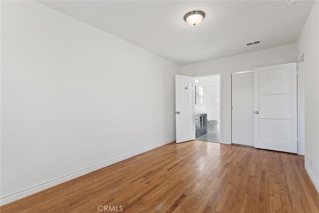 unfurnished bedroom with wood-type flooring