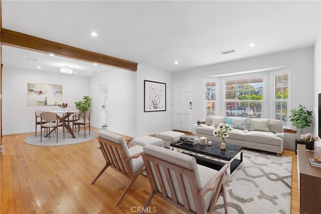 living room with beam ceiling and light hardwood / wood-style flooring