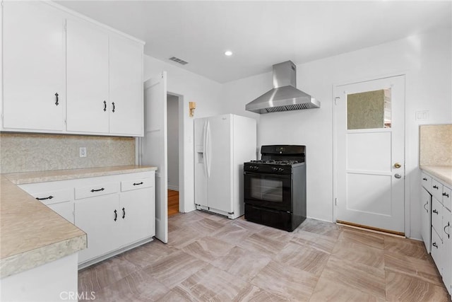 kitchen featuring backsplash, gas stove, white refrigerator with ice dispenser, white cabinets, and wall chimney exhaust hood