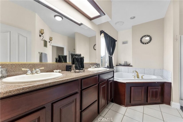 bathroom featuring vanity, tile patterned floors, and a washtub