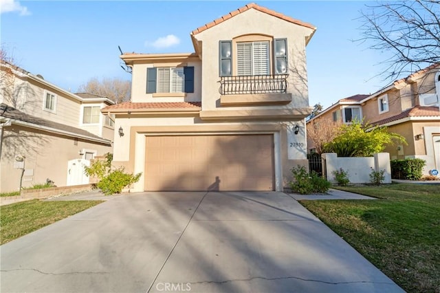 mediterranean / spanish-style home with a garage, a front lawn, and a balcony