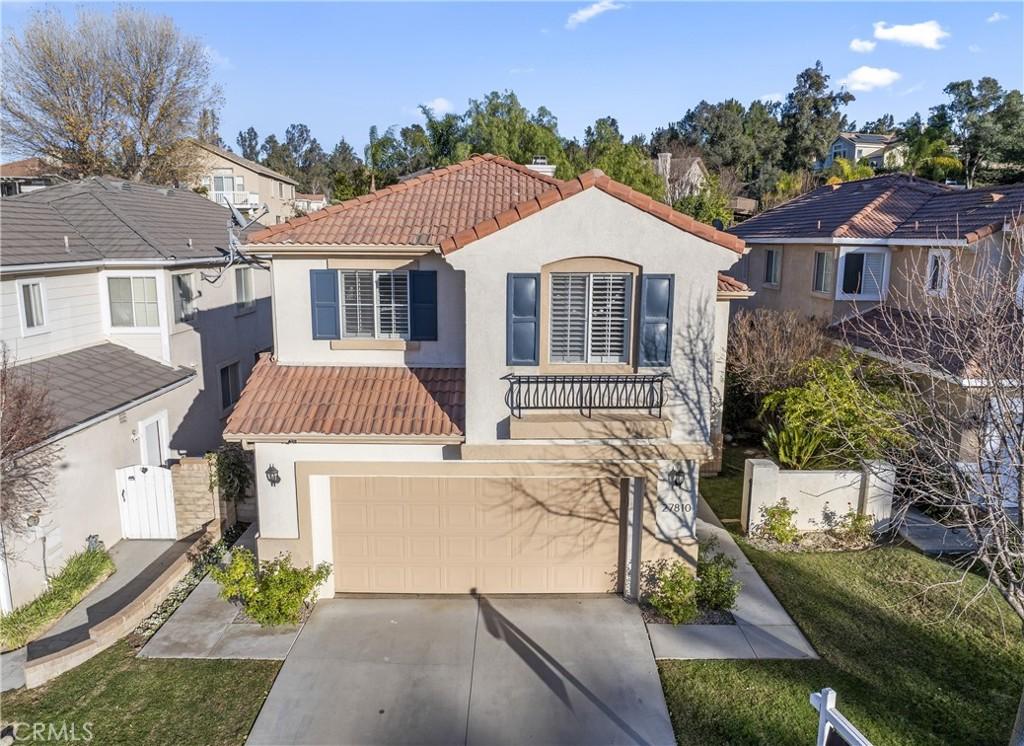 view of front of property featuring a garage and a front lawn