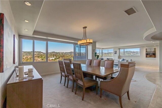 dining area featuring light carpet