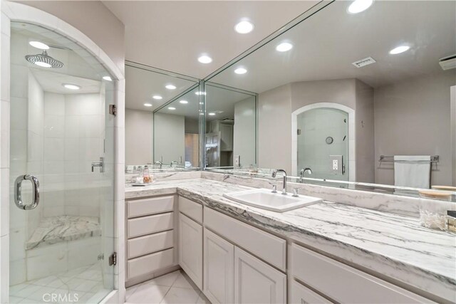 bathroom featuring an enclosed shower, vanity, and tile patterned floors