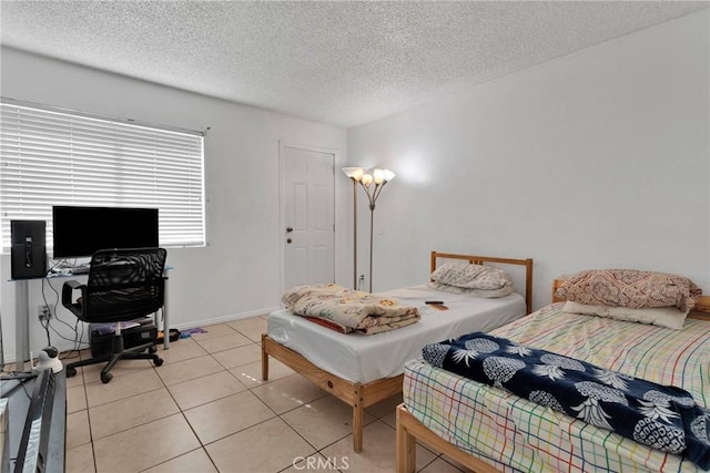 tiled bedroom with a textured ceiling