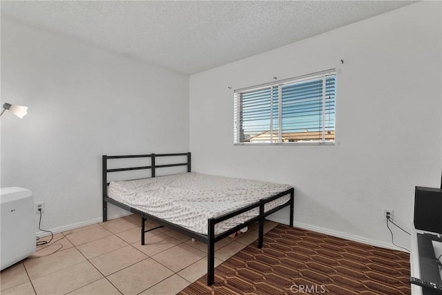 bedroom with tile patterned flooring and a textured ceiling