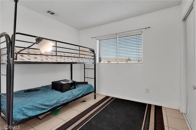 bedroom featuring light tile patterned floors