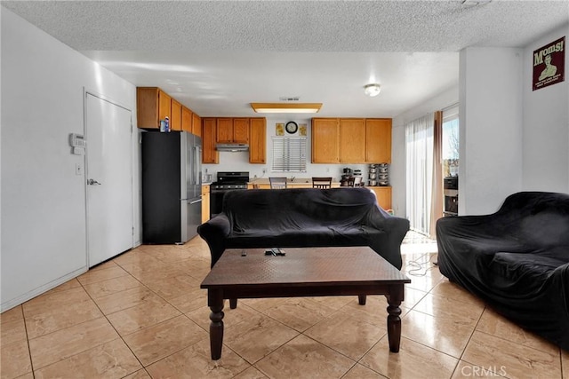 living room with light tile patterned floors and a textured ceiling