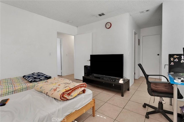 interior space featuring light tile patterned flooring and a textured ceiling