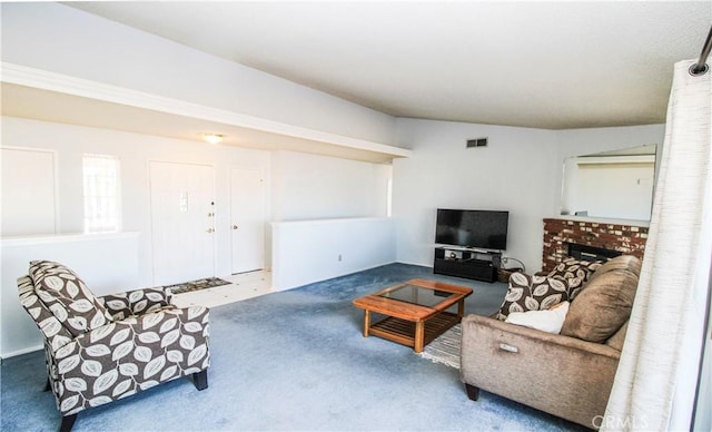 living room with vaulted ceiling and a brick fireplace