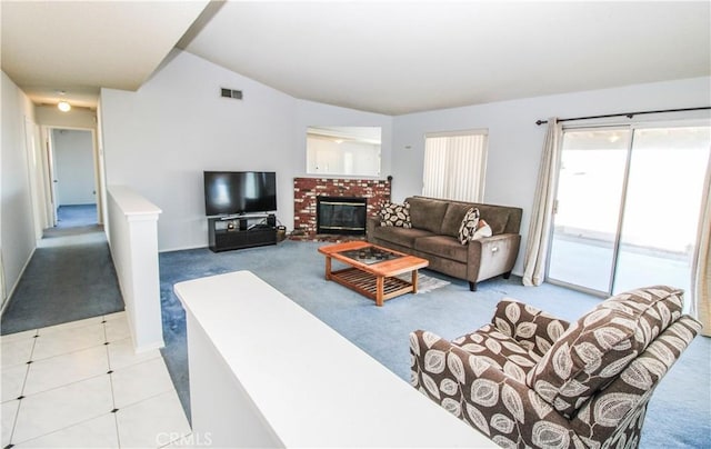 living room featuring light carpet, vaulted ceiling, and a fireplace