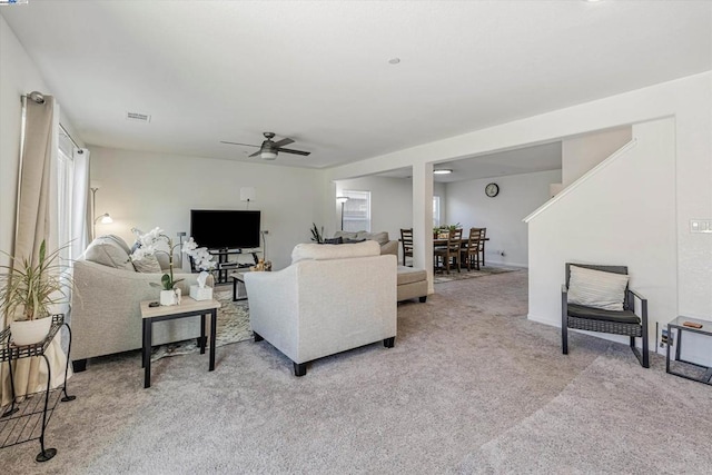 living room with ceiling fan and light colored carpet