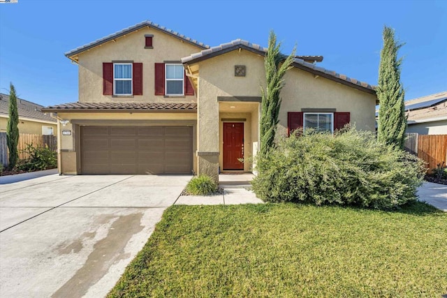 mediterranean / spanish home with a garage and a front lawn