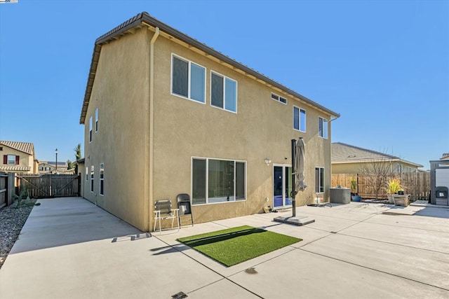 rear view of house featuring a patio area and central air condition unit