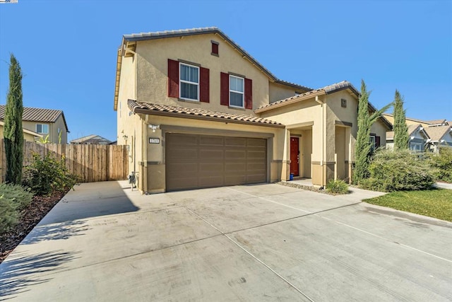 mediterranean / spanish home with a garage