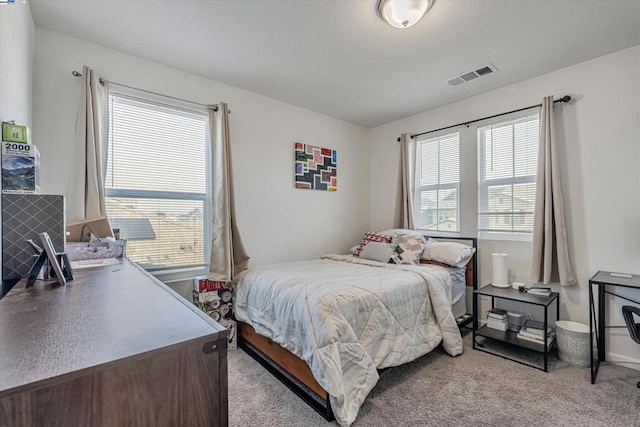 bedroom featuring light colored carpet