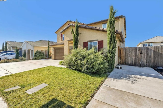 view of front of home featuring a garage and a front yard