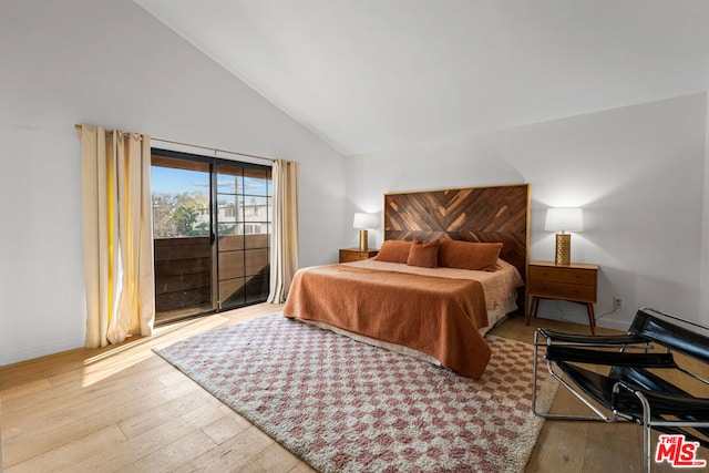 bedroom with light wood-type flooring, lofted ceiling, and access to outside