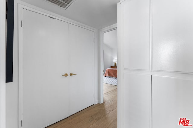 hallway with light hardwood / wood-style floors