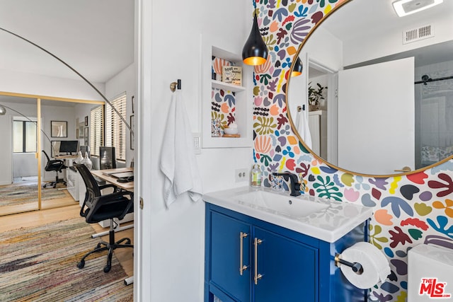 bathroom featuring wood-type flooring and vanity