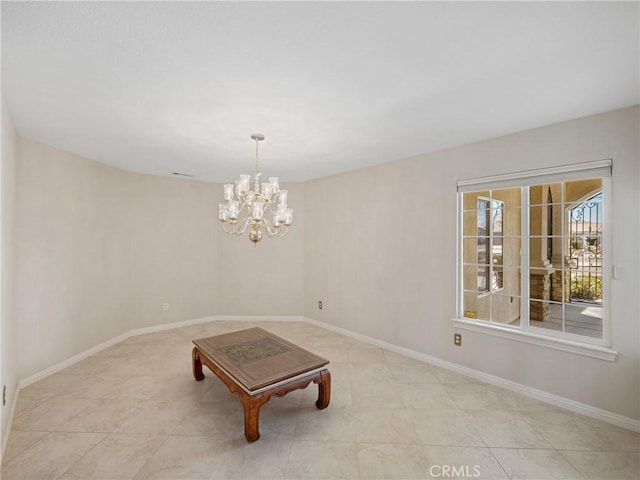 unfurnished room featuring a notable chandelier