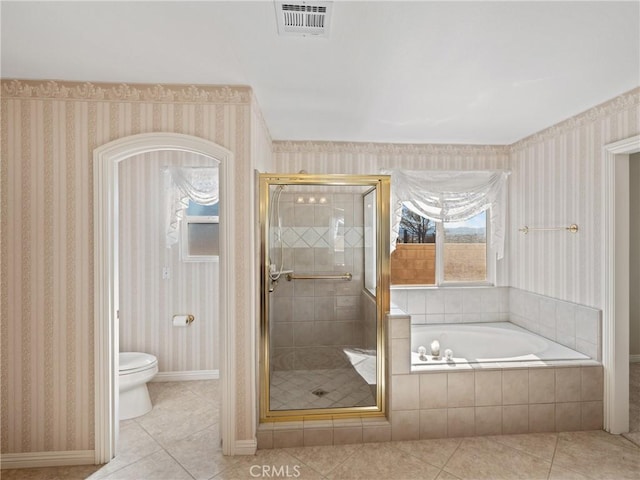 bathroom featuring toilet, tile patterned flooring, and plus walk in shower