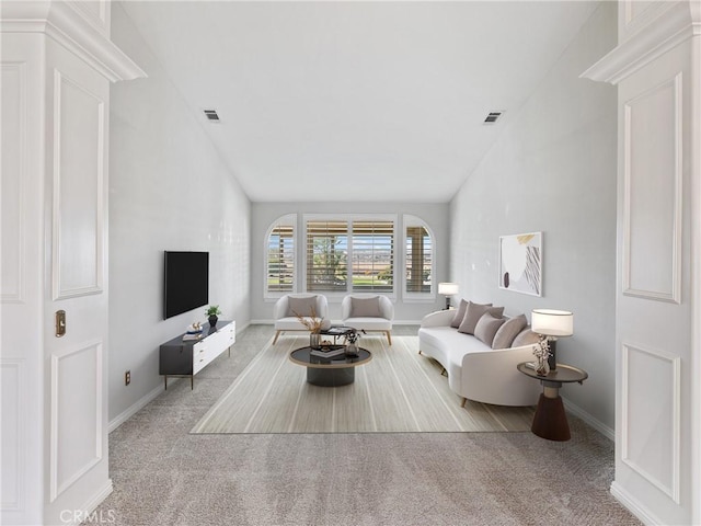 carpeted living room with lofted ceiling