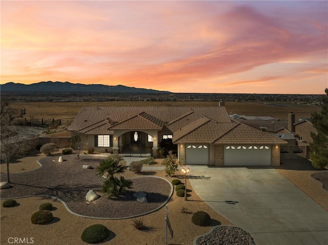 view of front of property featuring a garage and a mountain view