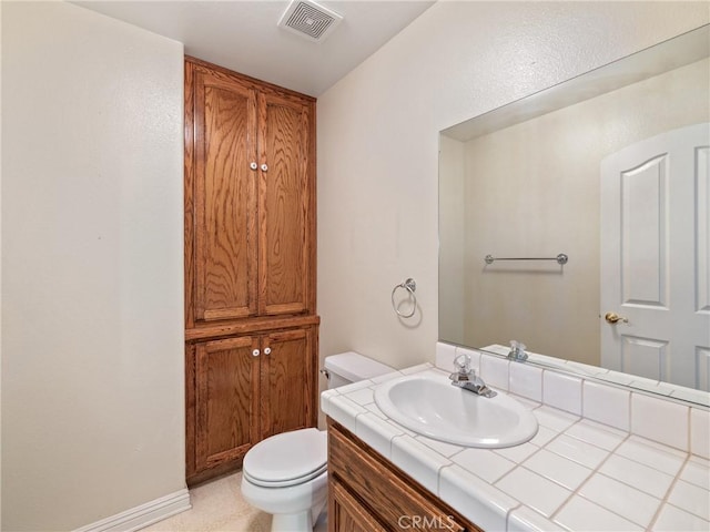 bathroom with toilet and vanity