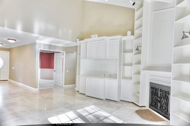 unfurnished living room featuring ornamental molding