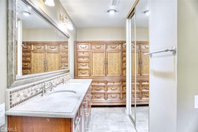 bathroom with vanity and decorative backsplash