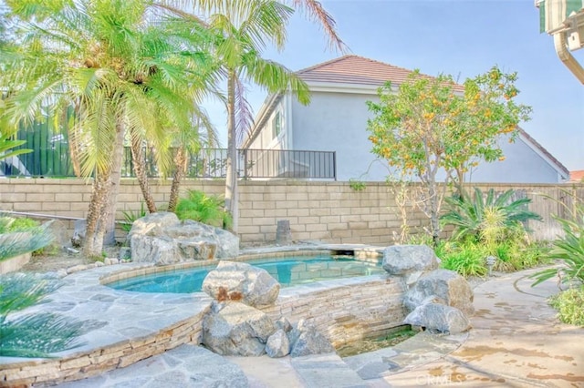 view of pool with a hot tub