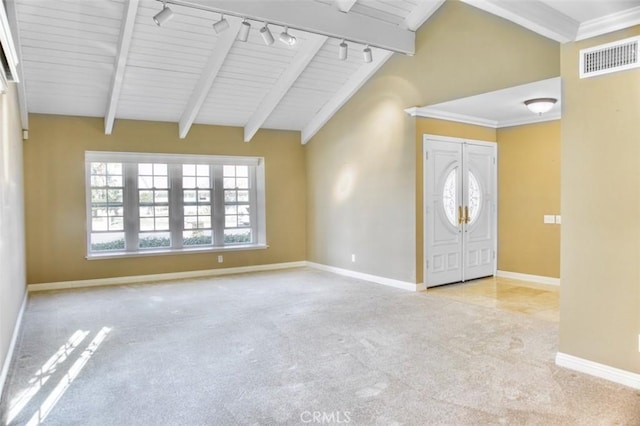 carpeted foyer featuring rail lighting, wood ceiling, and vaulted ceiling with beams