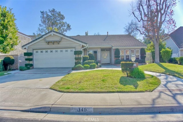 ranch-style home with a garage and a front lawn