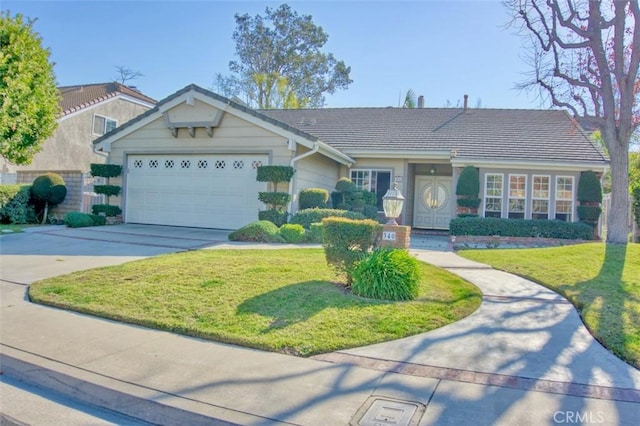 view of front of home featuring a garage and a front yard