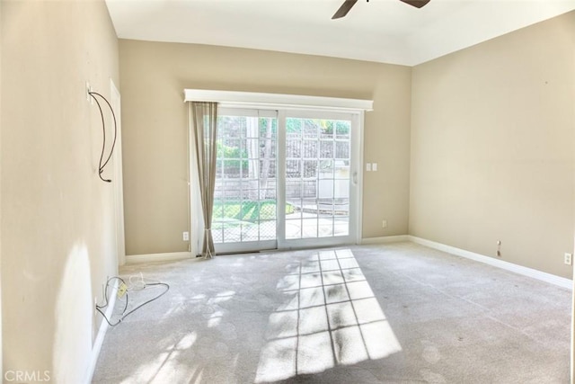 carpeted spare room with ceiling fan