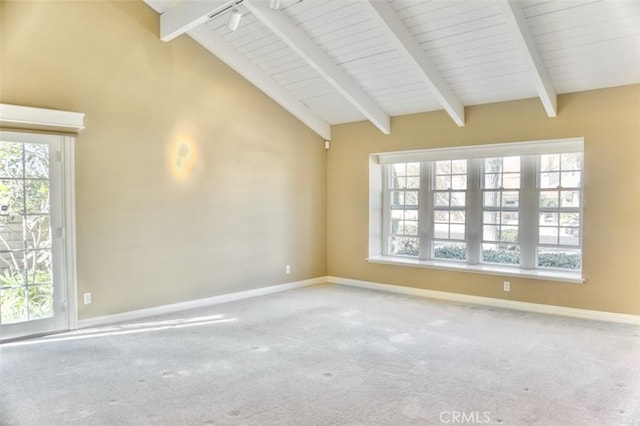 carpeted spare room featuring lofted ceiling with beams