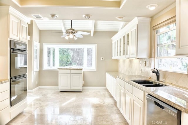 kitchen with multiple ovens, white cabinetry, stainless steel dishwasher, and sink