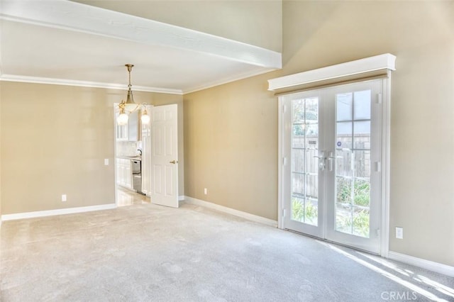 empty room with an inviting chandelier, carpet flooring, ornamental molding, and french doors