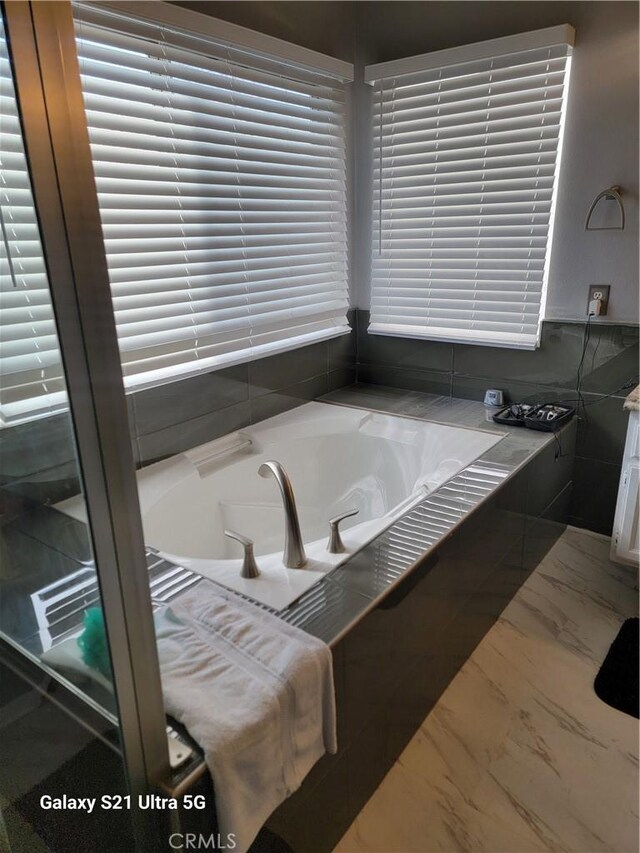 bathroom with tiled tub