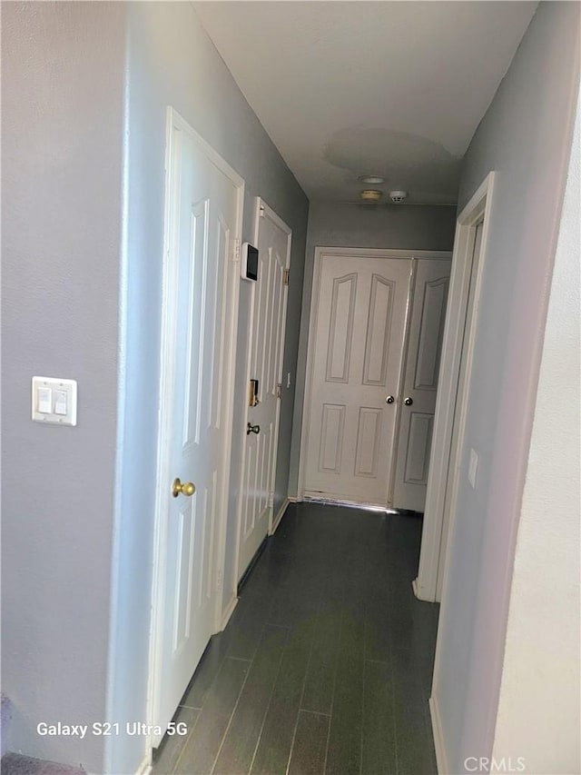 hallway with dark hardwood / wood-style flooring